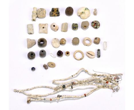 A group of ancient jewellery beads, one fashioned as a necklace on modern stringing, of varied size and form including carved