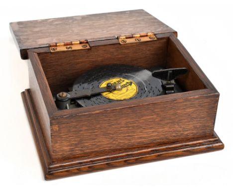 THORENS; an oak cased Symphonium-type small disc player, with Thorens disc, 'Skaters 442', the case 9.5 x 22 x 16.5cm.Additio