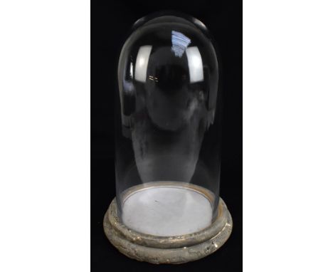 A contemporary glass dome on ceramic stand, height 36cm.
