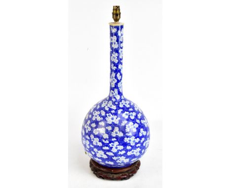 A 20th century East Asian bottle vase converted to a lamp featuring blossoming prunus against crackled blue ground, height ex