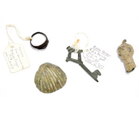 A Roman metal 'mint' in the form of a shell used for repoussé work, probably Syrian, width 3.2cm, a miniature head, possibly 
