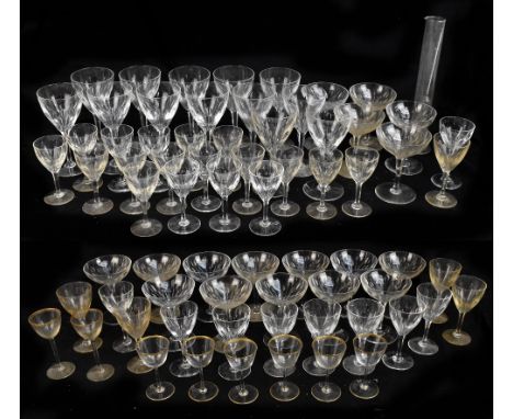A suite of cut glassware comprising wine glasses, champagne saucers, each with linear wheel cut decoration, together with a s