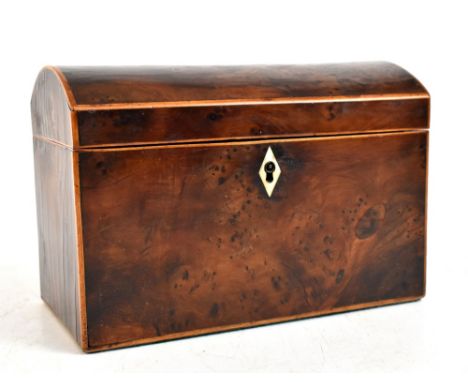 An early 19th century yew wood dome topped tea caddy, the hinged cover enclosing two compartments, with ivory escutcheon, len