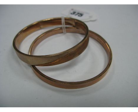 A 9ct Gold Bangle, of flat plain design; together with another similar, stamped "9ct". (2)