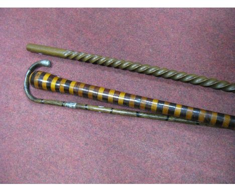 A Circa 1900 Walking Cane, decorated in alternative light and dark wood ring, a cane walking stick with white metal collar, a