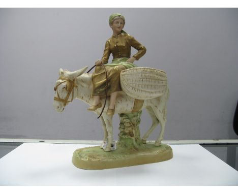 An Early XX Century Royal Dux Model of a Young Girl Seated Upon on a Donkey, carrying two woven baskets, with rein, on natura