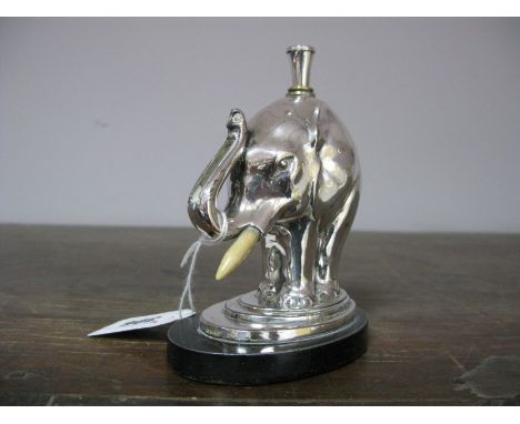 A Ronson Chromed Lighter, having match strike facility trunk, on an oval stepped base, 12cms high overall (trunk absent). 