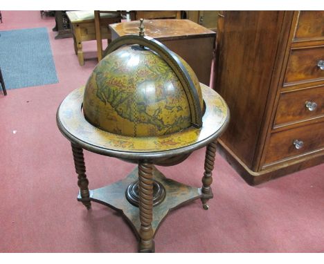 A Circa 1980's 'Kitch' Drinks Globe, with applied terrestrial design, flip top lid with fitted interior, all supported on fou