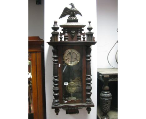 An Early XX Century Mahogany Cased Eight Day Vienna Wall Clock, the pediment with eagle crest over half turned columns and ma