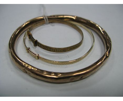 A 9ct Gold Bangle, (dented), together with two expanding bangles. (3)
