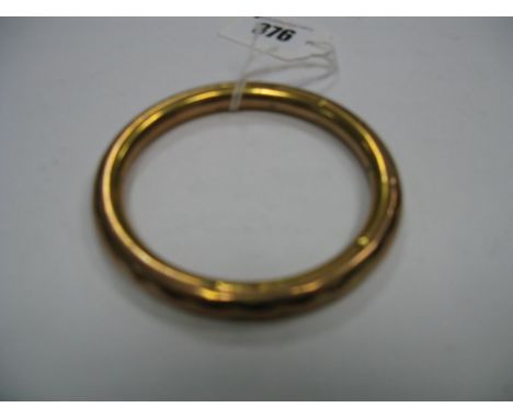 A 9ct Gold Bangle, with diamond cut decoration.