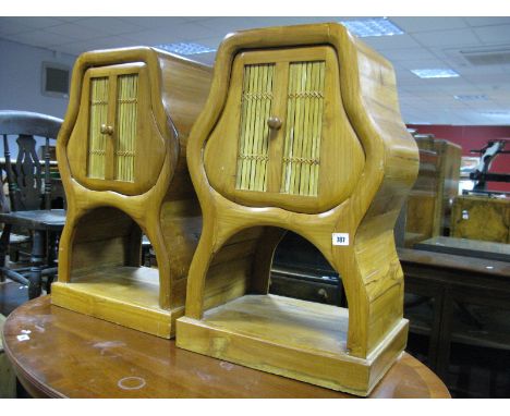 A Pair of Hardwood Caned Bedside Cabinets, of shaped form with a single drawer over an open shelf plinth bases. 