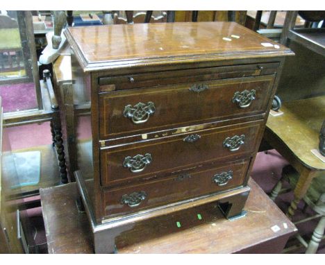 A XX Century Walnut Chest of Drawers, with a crossbanded top, moulded edge, brushing slide, three long drawers on bracket fee