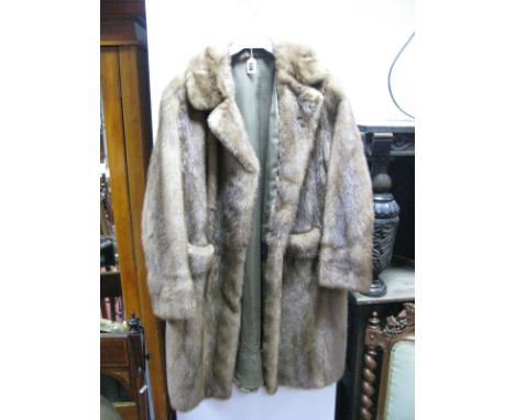 A Light Brown Knee Length Mink Coat, with front pockets, button trimmed back half belt, retailers label "Crown Furs" London, 