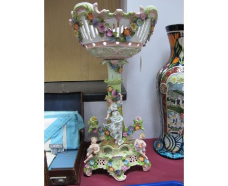 A Late XIX Century Sitzendorf Style Porcelain Table Centrepiece, of basket and pedestal form, pierced, heavilly encrusted wit