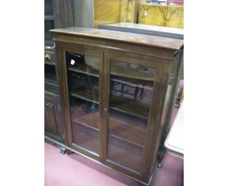 An Early XX Century Stained Mahogany Bookcase, stepped cornice glazed doors, knulled sides, on bracket feet with three intern