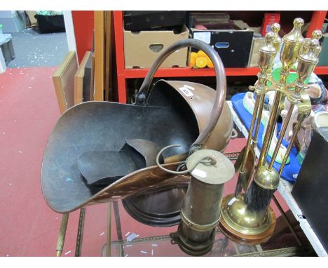 A XIX Century Copper Helmet Shaped Coal Scuttle, copper shovel, together with brass fire irons, on a stand, brass miners lamp