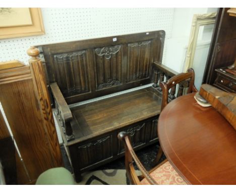 An oak monks bench, 122cms W 104cms H 56cms D