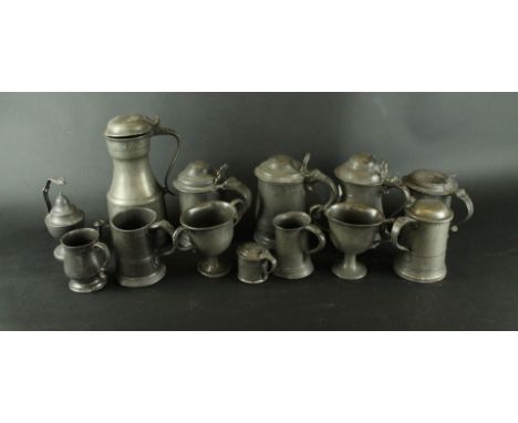 Twelve assorted 18th and 19th Century pewter tankards and loving cupsHeight of largest example 27cm, also a pewter oil lamp w