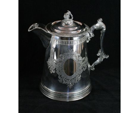 A late 19th century oversized silver plated lidded jug
Of tapered cylindrical form, with an applied gadrooned rim, the domed 