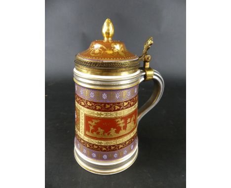 A large Vienna porcelain and metal mounted lidded tankardThe lid with acorn finial and foliate thumb piece, the body decorate