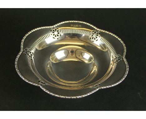 An Edward VII silver pedestal bowlOf lobbed pierced form, raised on a spreading circular base, hallmarked Chester 1908, maker