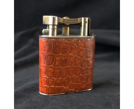 A Vintage chrome plated and crocodile skin effect Dunhill table lighter
Of rectangular form, height 11cm. CONDITION REPORT: 8