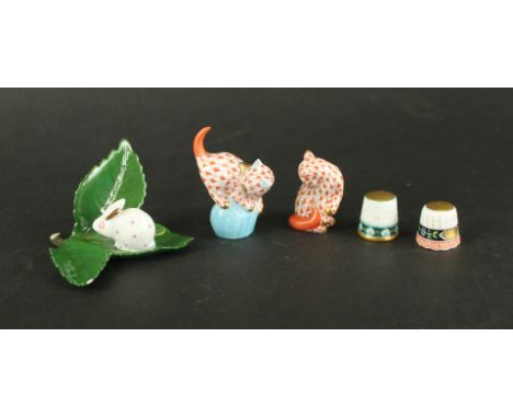 A collection of Hungarian Herend figuresComprising two fish scale decorated model cats further rabbit on leaf and two further