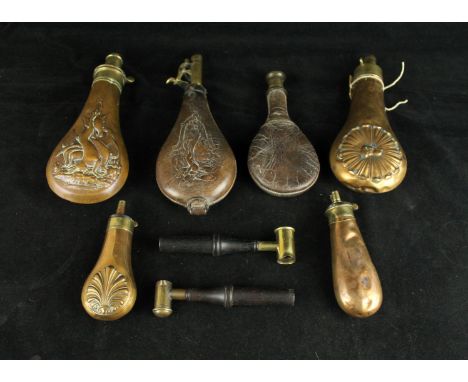A collection of four copper and brass powder flasks, mid 19th CenturyOne decorated with hunting scenes, the other with a dogs