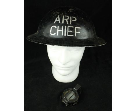 A WWII black painted Brodie helmetThe black painted helmet with silver lettering ARP Chief, WWII period British Military comp