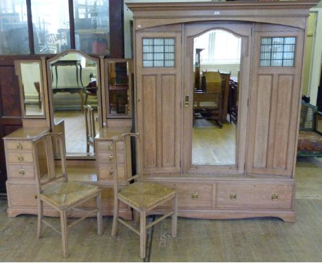 A fine quality early 20th Century light oak Gothic Arts & Crafts bedroom suite, stamped WaringsComprising triple wardrobe wit