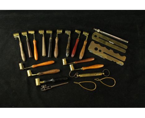 A collection of fourteen wooden handled and brass powder measures, late 19th/early 20th Century The measures with adjustable 