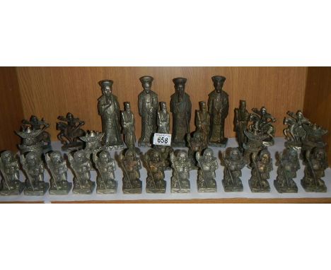 An oriental style heavy cast chess set.There are 32 pieces.Height of pawn 9cm.Height of King 18cm