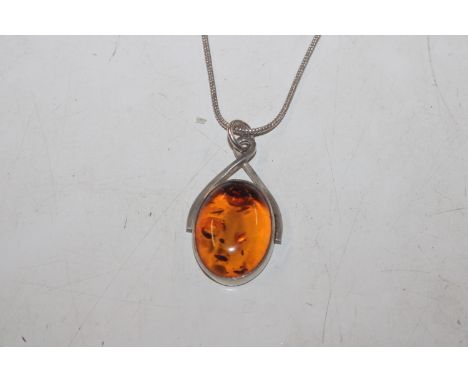A vintage Sterling silver and amber pendant on chain 