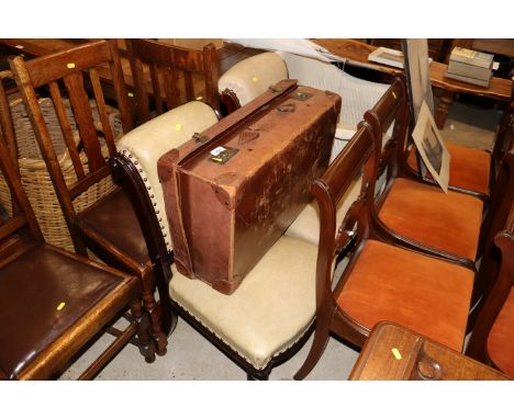 A pair of leather upholstered mahogany armchairs; and a vintage leather case
