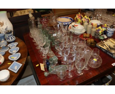 A large quantity of table glassware and vintage glass bottles; a 19th Century rummer and other glassware 