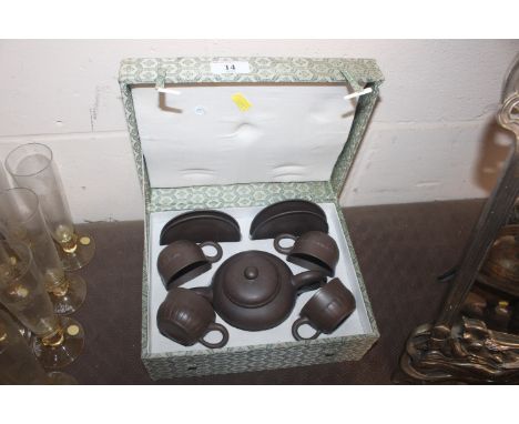 A cased Chinese Yixing tea set with impress seal marks 