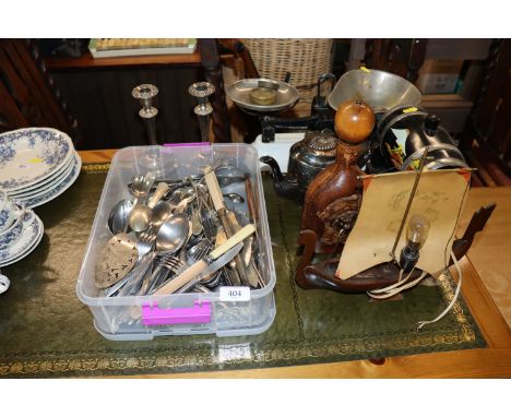 A box of various flatware, silver plated candlesticks, silver plated teapot, scales and weights, spirit barrel, table lamp in