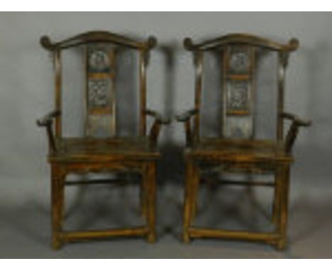 A pair of late 19th / early 20th century Chinese carved hardwood elbow chairs, with scroll carved cresting rails above splats