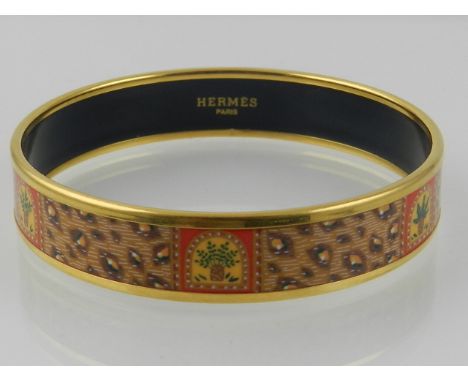 A Hermes of Paris bangle in cinnamon/orange colours, stamp to inside Hermes. 