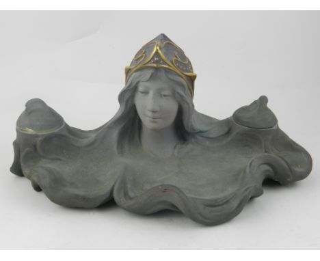 An Art Nouveau style ceramic desk inkwell, decorated with stylised head of a girl. W: 33cm