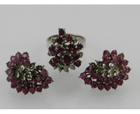 A white metal, diamond, and ruby set cocktail ring, together with an associated pair of white metal, diamond and ruby set ear