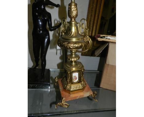 A regency style lamp base, gilt metal inset with porcelain plaques, raised on four feet on a square base 