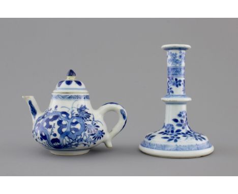 A Chinese blue and white porcelain candlestick and a miniature teapot, 18th C. H.: 10 cm (the candlestick)      Provenance: T