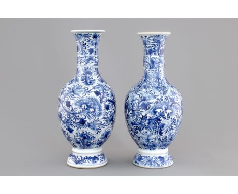 A pair of Chinese porcelain blue and white flower scroll vases, Kangxi, ca. 1700 H.: 27 cm     Condition: Each with some repa