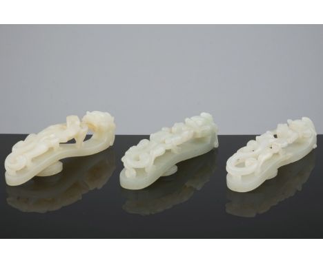 A set of 3 fine pale celadon jade belt hooks, 18/19th C. L.: 8,7 cm Condition reports and high resolution pictures are availa