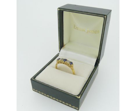 A graduated sapphire and diamond five stone Ring, the central sapphire approx. 3.5mm diameter, all mounted in 18ct gold in a 