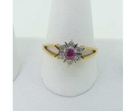 A small ruby and diamond cluster Ring, mounted in 18ct yellow and white gold with split shoulders, Size R½, 3.6g. 