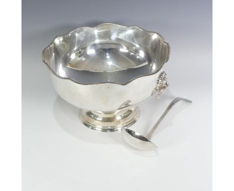 A silver plated Punch Bowl, with lion mask ring handles, 32cm diameter, 20cm high, together with a bead pattern ladle (2) 