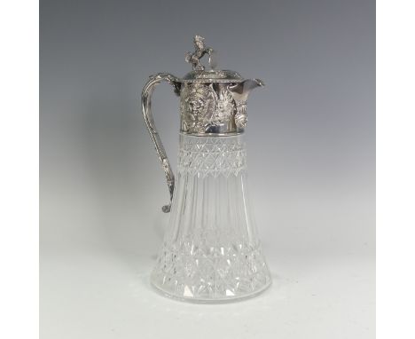 A silver plate mounted cut glass Claret Jug, in the manner of Elkington &amp; Co., the collar with figural masks and hinged c